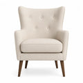 Sillón orejero de lino beige con patas de madera